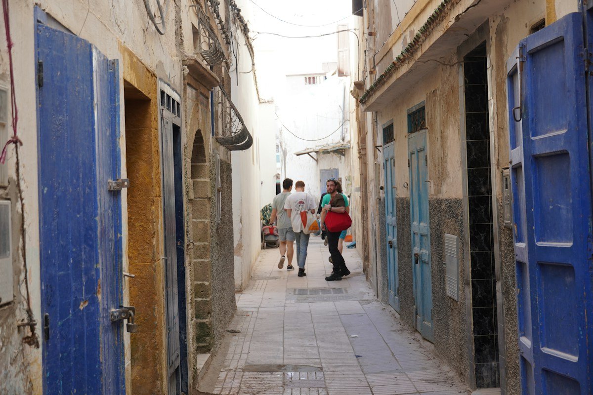 Narrow medina street with blue shutters in Essaouira, Morocco